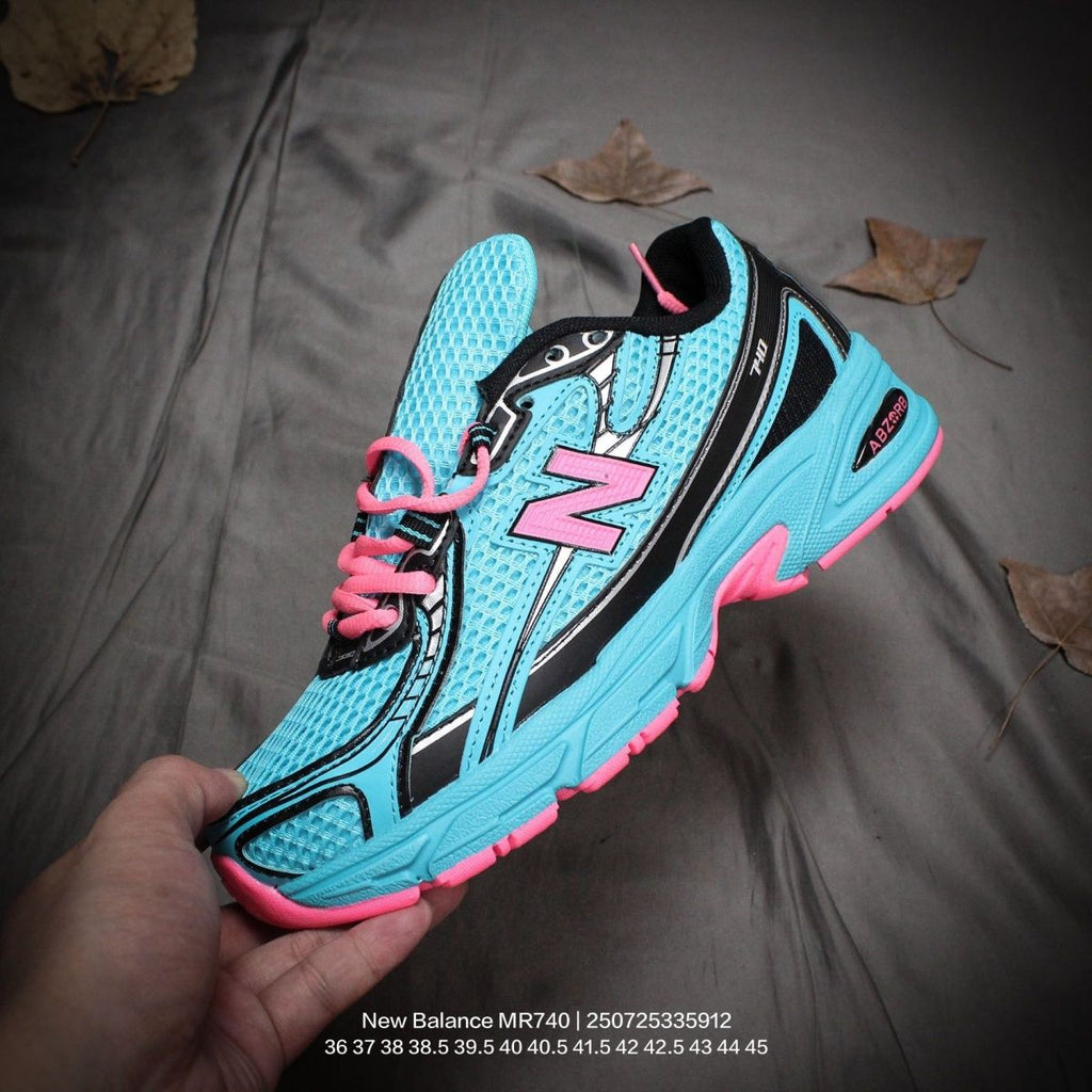 The New Balance 740v2 Cyber Jade features a breathable mesh upper with vibrant blue and neon pink accents, inspired by 2000s running style