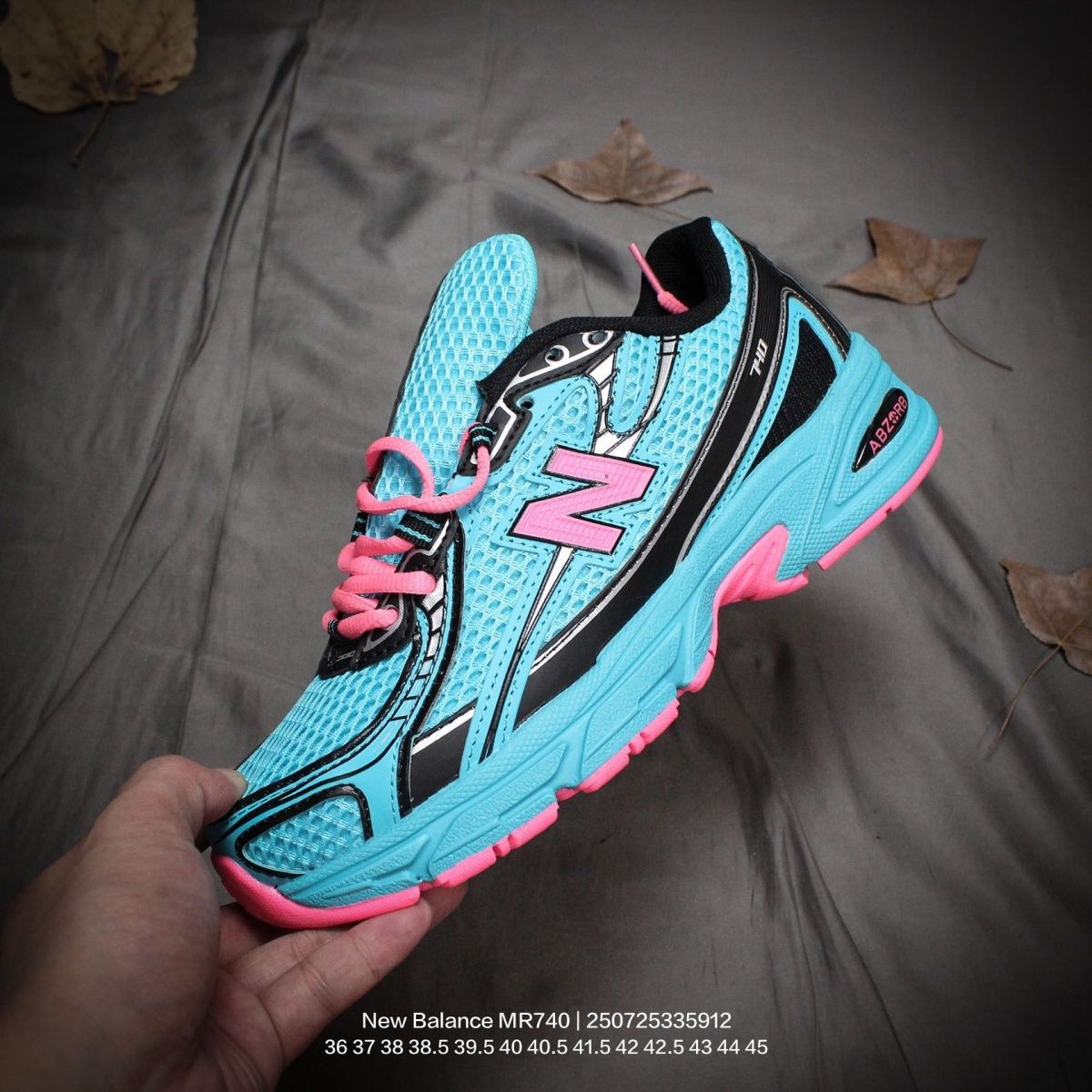 The New Balance 740v2 Cyber Jade features a breathable mesh upper with vibrant blue and neon pink accents, inspired by 2000s running style