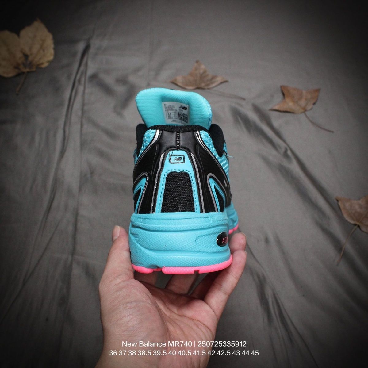 The New Balance 740v2 Cyber Jade features a breathable mesh upper with vibrant blue and neon pink accents, inspired by 2000s running style