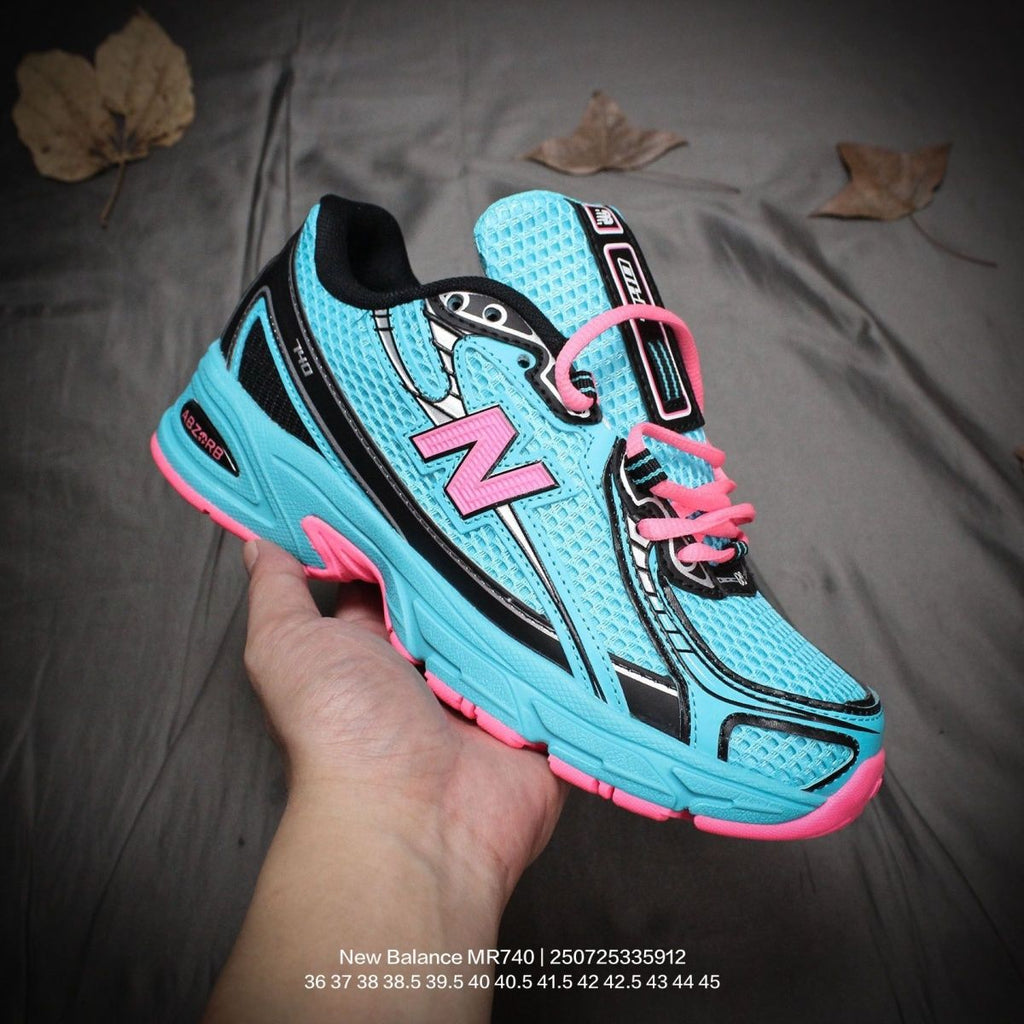 The New Balance 740v2 Cyber Jade features a breathable mesh upper with vibrant blue and neon pink accents, inspired by 2000s running style