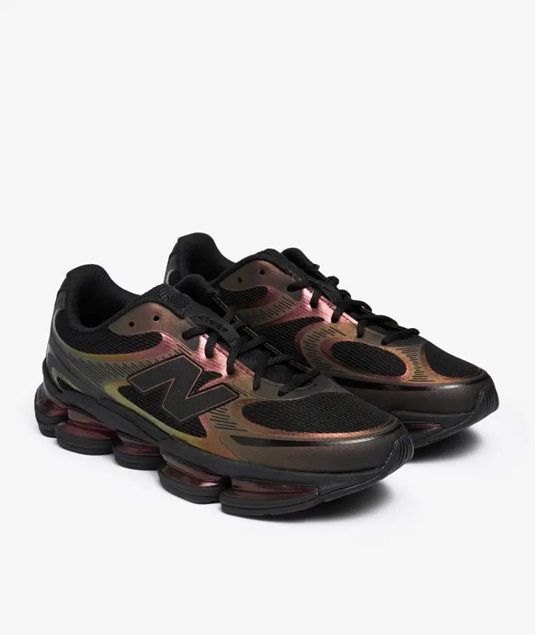 New Balance Abzorb 2000 in the Iridescent colorway (model U2000PPB) is a lifestyle sneaker featuring a black mesh upper with shimmering iridescent overlays and a five-pod cushioned sole unit.